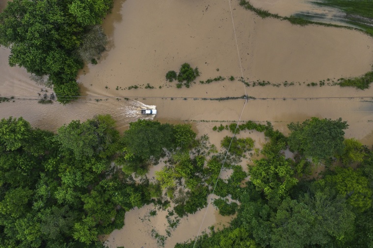 Image: A truck drives along flooded Wolverine Road in Breathitt County, Ky., on July 28, 2022.