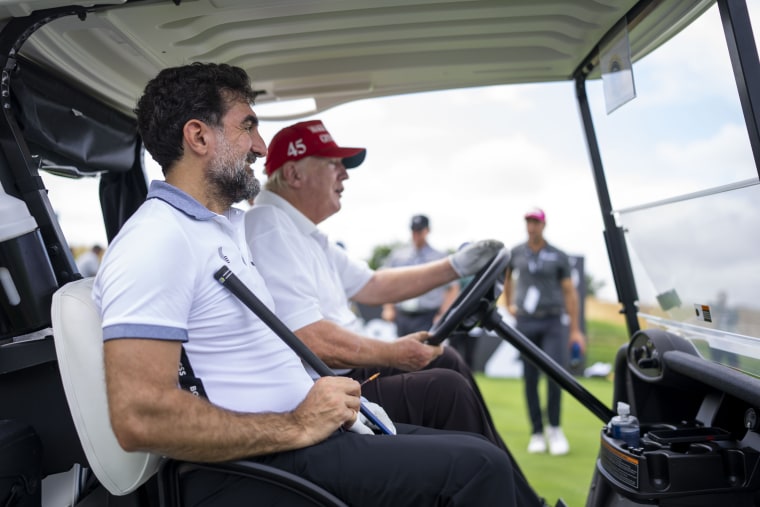 Image:Former president Donald Trump drives a golf cart with Yasir Al-Rumayyan, head of the sovereign wealth fund of Saudi Arabia at the Trump National Golf Club in Bedminster, NJ on July 28, 2022.