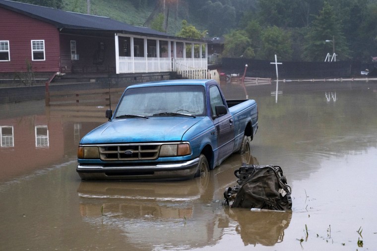 Receded water levels from the Kentucky River surround a truck