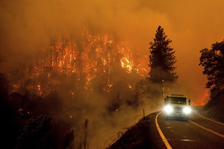 A firetruck drives along California Highway 96 as the McKinney Fire burns in Klamath National Forest, Calif., Saturday, July 30, 2022.