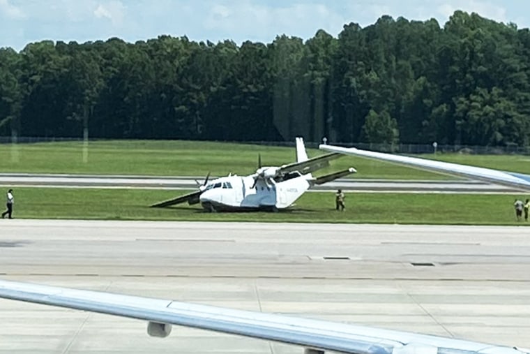 A CASA CN-212 twin-engine Aviocar is inspected after an emergency landing at Raleigh-Durham International Airport