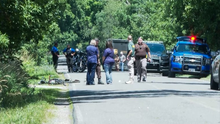 Police respond to the scene of a crash where an intoxicated driver struck and killed cyclists participating in the Make A Wish Bicycle Tour in Ronald Township, Mich., on July 30, 2022.