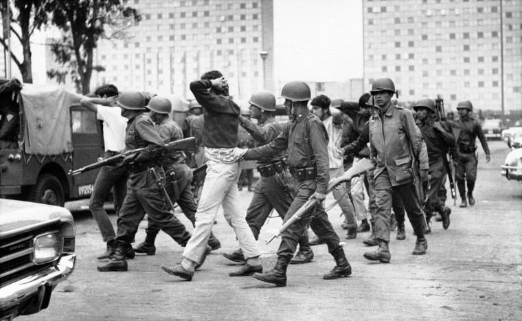 On Oct. 3 1968, army troops escort a group of young men from Mexico City's Plaza de las Tres Culturas, the scene of bloody clashes. (AP Photo)