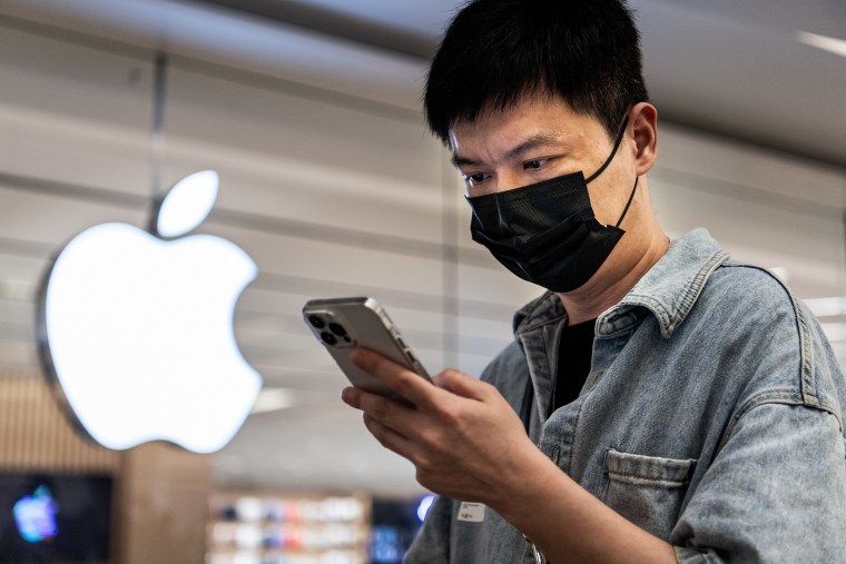 Un cliente chino mira un teléfono en la inauguración oficial de la nueva Apple Store en el Wuhan International Plaza, el 21 de mayo de 2022.