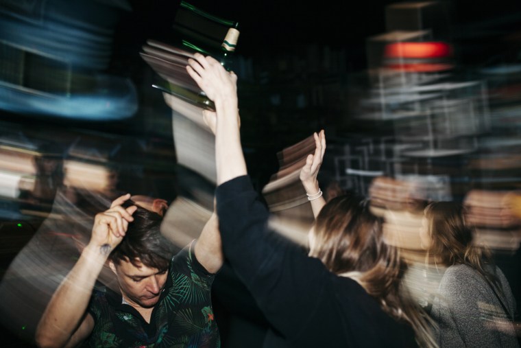 Energetic Scene Of People On Dancefloor At Nightclub