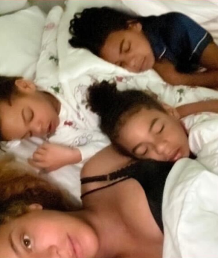 Beyonce shared a rare photo of herself lounging in bed with her three children: Blue Ivy, Rumi an Sir.