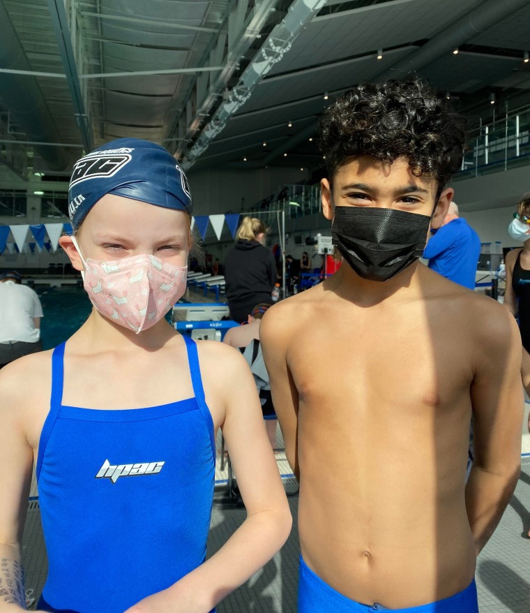 Amy Kiefer's 7-year-old daughter and Kiefer's best friend's older son, posing before a swim meet during happier times.