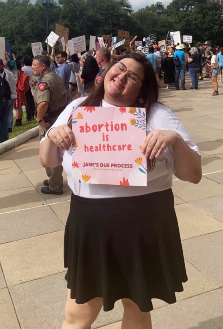 A photo of Olivia Julianna at a rally for abortion access.
