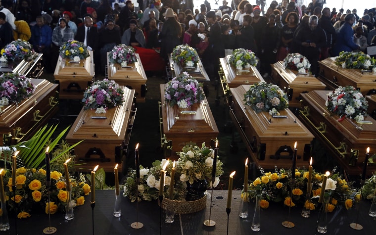Coffins of 21 teenagers who died in a mysterious tragedy at a nightclub in the early hours of June 26, 2022 are lined up during their funeral.