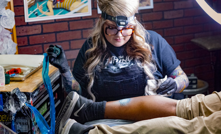 A Bad Apple Tattoo artist inking a Subway super fan.