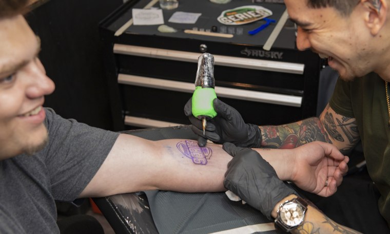 Participant Michael Booker getting a Subway Series tattoo at Bad Apple Tattoo.