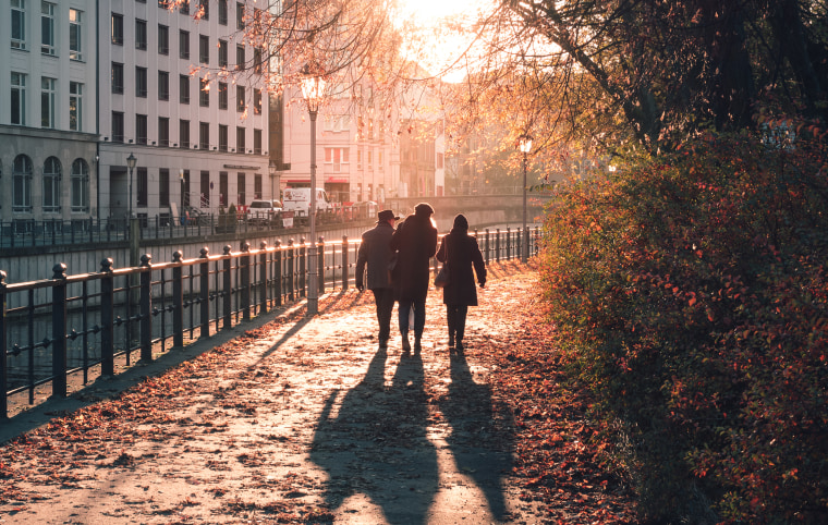 People Walking By Canal In City