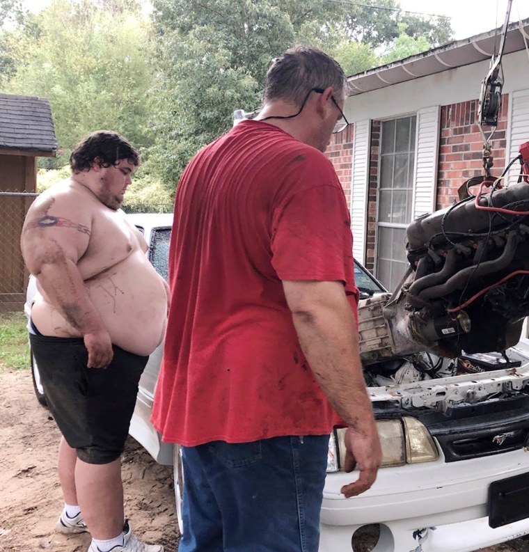 Lowe, left, gets some help restoring a car from his father. When the project was finished, Lowe found he couldn't fit inside the vehicle.