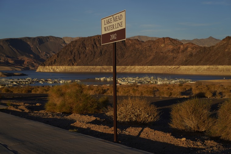 A sign marks the water line from 2002 near Lake Mead at the Lake Mead National Recreation Area, Saturday, July 9, 2022, near Boulder City, Nev. More human remains were found over the weekend at the shrinking lake. (AP Photo/John Locher)