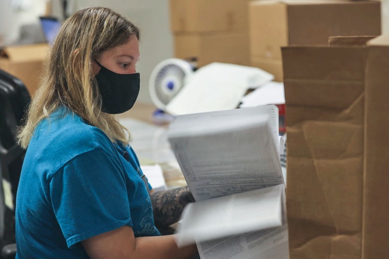 An ATF worker flips through gun sale records in Martinsburg, W.Va.