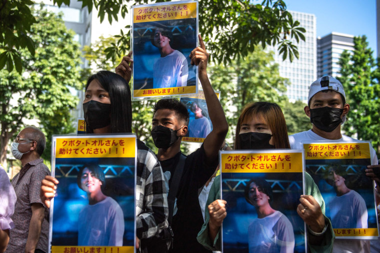 Image: A group of activists hold placards of Japanese citizen Toru Kubota, who is detained in Myanmar, during a rally in front of the Ministry of Foreign Affairs in Tokyo on July 31, 2022.