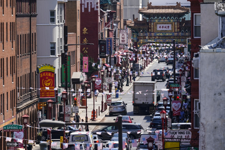 Image: Traffic drives down 10th Street in the Chinatown neighborhood of Philadelphia July 22, 2022.