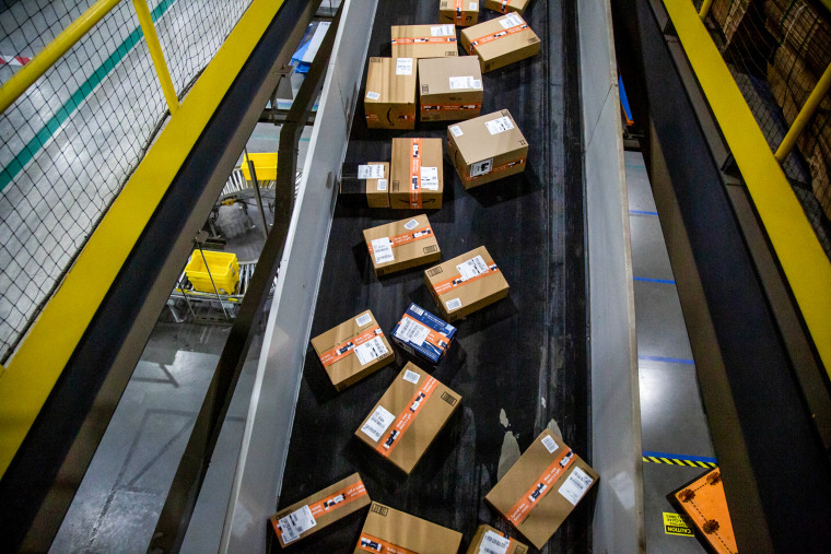 Packages move along a conveyor at an Amazon fulfillment center in Robbinsville, N.J., on Nov. 29, 2021.