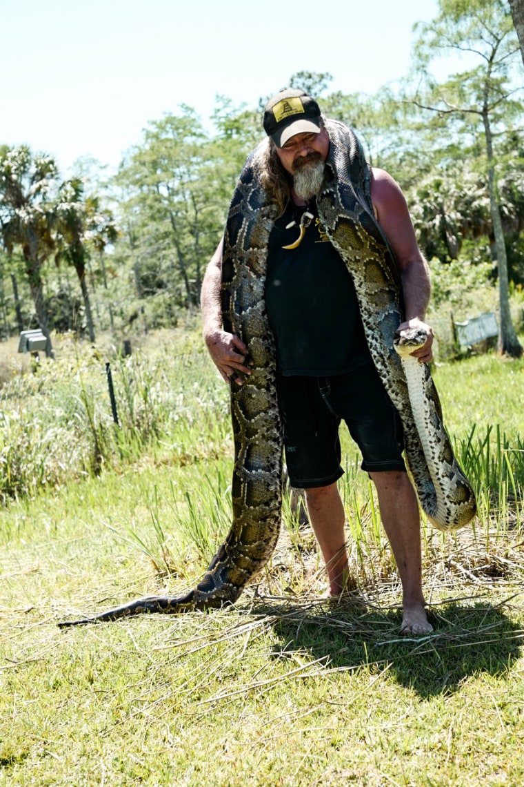 Dusty Crum holds a snake in Florida in 2017.