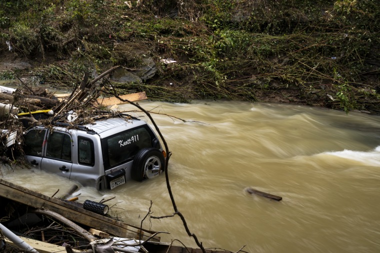 Image: A Knott County emergency vehicle gathers debris in the flooded Troublesome Creek in downtown Hindman, Ky. on Aug. 2, 2022.