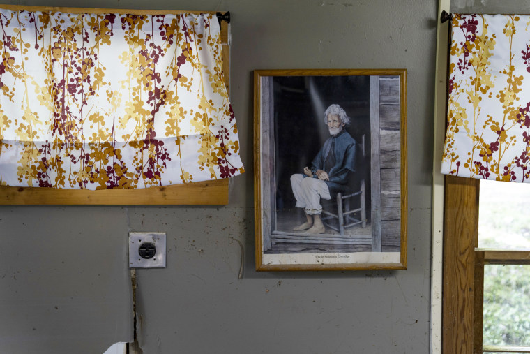 Image: A picture of Uncle Solomon Everidge, who donated the land for the Hindman Settlement School in 1902, is covered in mud on Aug. 2, 2022.