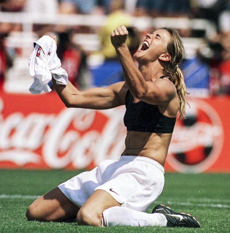 Brandi Chastain celebrates by taking off her jersey after kicking the game-winning penalty shootout goal against China in the Women's World Cup Final in 1999.  