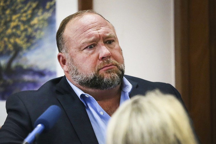 Conspiracy theorist Alex Jones attempts to answer questions about his emails asked by Mark Bankston, lawyer for Neil Heslin and Scarlett Lewis, during trial at the Travis County Courthouse in Austin on Aug. 3, 2022.