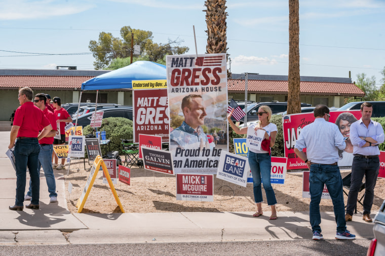 Image: Campaign workers and signs outside a polling location at the Scottsdale Worship Center  on August 2, 2022 in Scottsdale, Ariz..