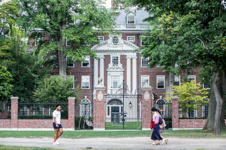 Pedestrians walk past a Harvard University building on Aug. 30, 2018, in Cambridge, Mass.