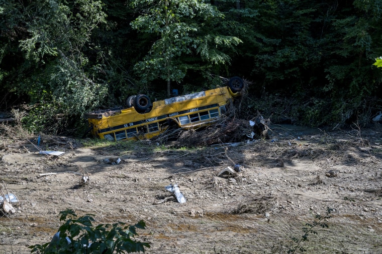 Image: A Perry County school bus is flipped over in River Caney Creek in Breathitt County, Ky. on Aug. 3, 2022.
