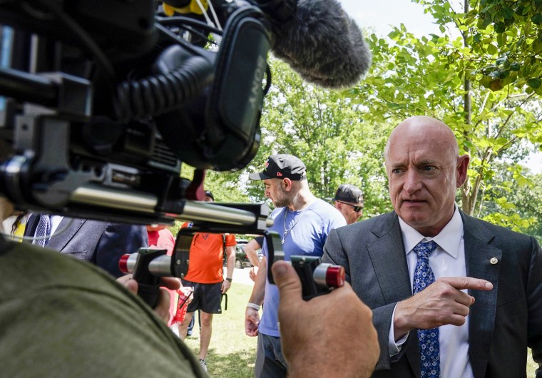 Sen. Mark Kelly, D-Ariz., speaks with members of the media as veterans, military family members and advocates, rally outside the Capitol in Washington on Aug. 2, 2022, in support of a bill that enhances health care and disability benefits for millions of veterans exposed to the toxic burn pits.