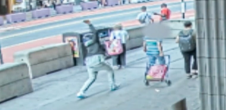 Police have charged a man with assault as a hate crime after allegedly slashing an Asian woman with a box cutter, seen here in surveillance footage.