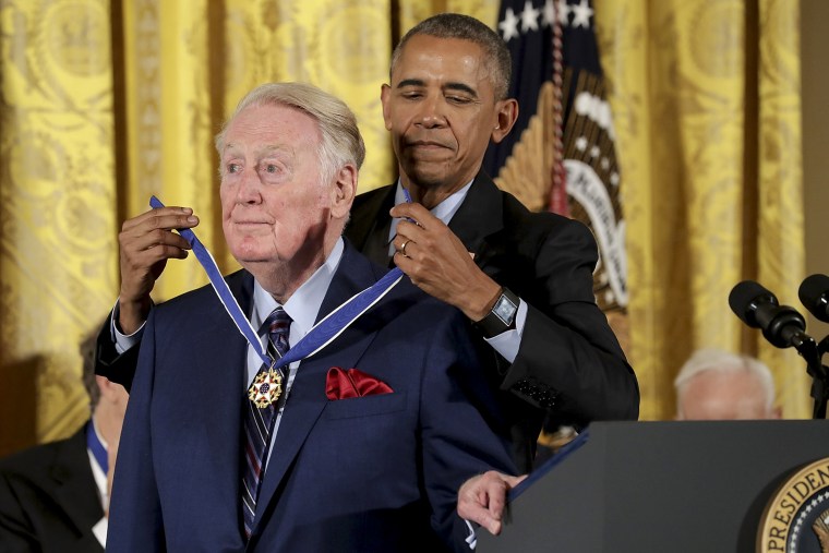 Image: Former U.S. President Barack Obama awards the Presidential Medal of Freedom to broadcaster and National Baseball Hall of Fame inductee Vin Scully during a ceremony in the East Room of the White House November 22, 2016 in Washington.