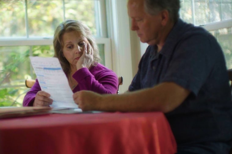 Image: Jackie Trapp looks over a billing statement in Muskego, Wisc.