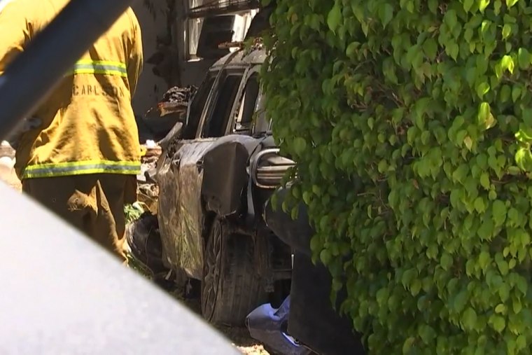 A firefighter works near the car that is believed to belong to Anne Heche after an accident in mar Vista, Calif., on Friday.