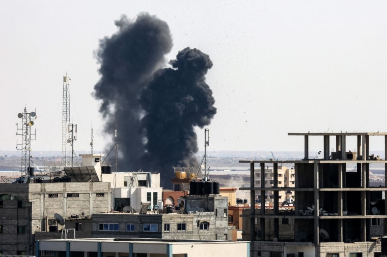 Smoke billows from a building hit during an Israeli airstrike in Rafah, southern Gaza Strip, on August 7, 2022.