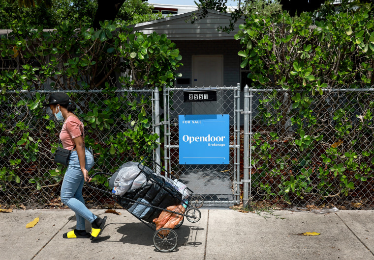 A 'for sale' sign hangs in front of a home on June 21, 2022 in Miami.