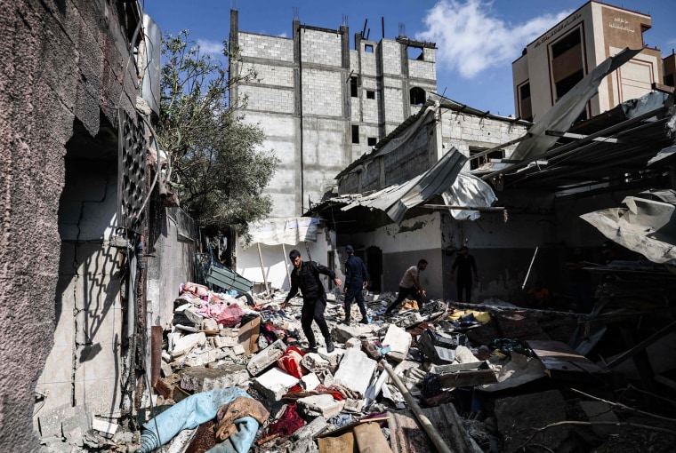 Palestinian police officers assess the damage in the Jabalia refugee camp in the northern Gaza Strip on Aug. 7, 2022.