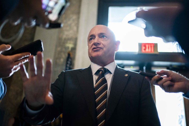 Sen. Mark Kelly, D-Ariz., talks with reporters in the Capitol on July 27. 