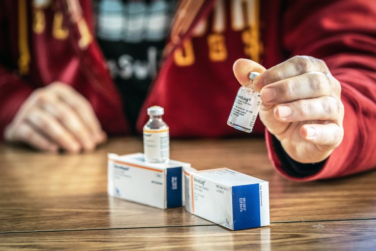 A man holds a vial of NovoLog, a replacement insulin drug, at his house on Jan. 16, 2020 in Eveleth, Minn.