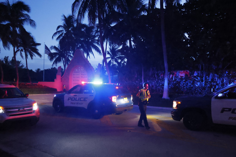 Police direct traffic outside an entrance to former President Donald Trump's Mar-a-Lago estate in Palm Beach, Fla., late Monday.