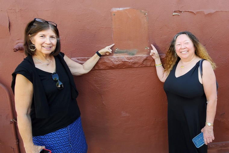 Image: Heather Clifton, left, and Linda Lung, descendants of families in historic Chinatown, point to the space where the plaque used to hang in Denver.