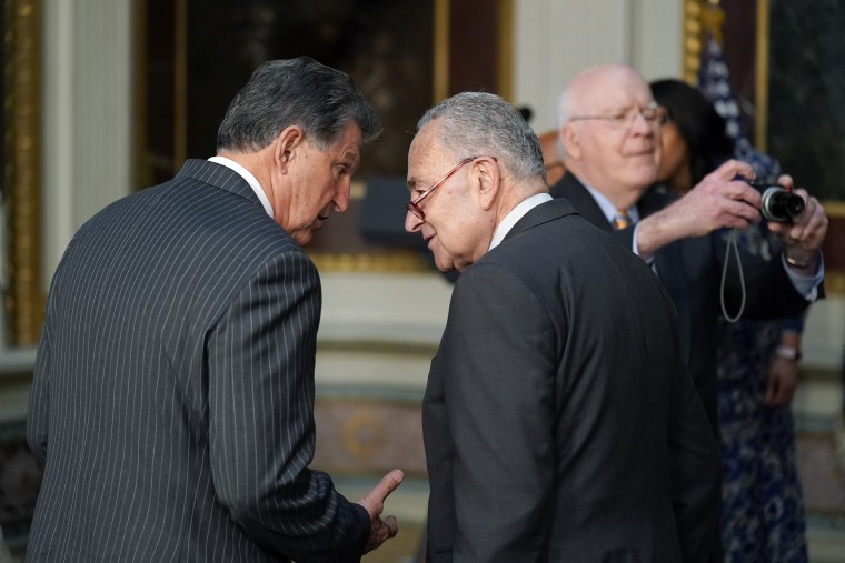 Sen. Joe Manchin, right, talks with Senate Majority Leader Chuck Schumer in the Eisenhower Executive Office Building on the White House Campus in Washington, D.C. on March 15.