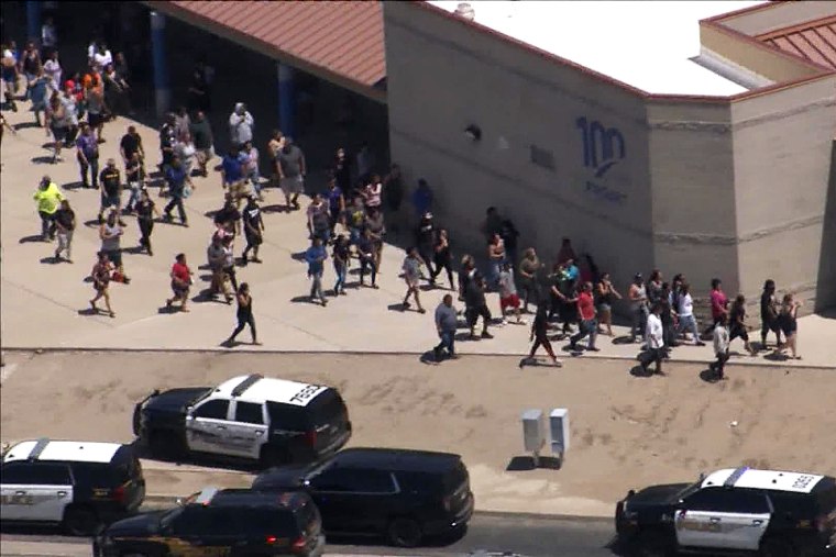 People walk outside the Thompson Ranch Elementary School during a school lockdown due to reports of a suspicious person on campus.