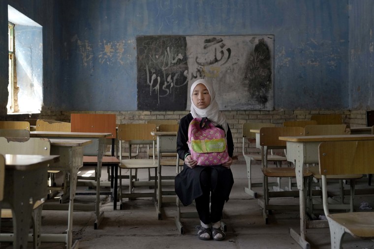 Fereshteh, 11, a Hazara Shiite student poses in her classroom in Kabul, on April 23, 2022.