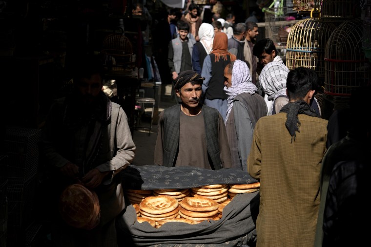 A bread seller waits for customers at a market in Kabul in April.