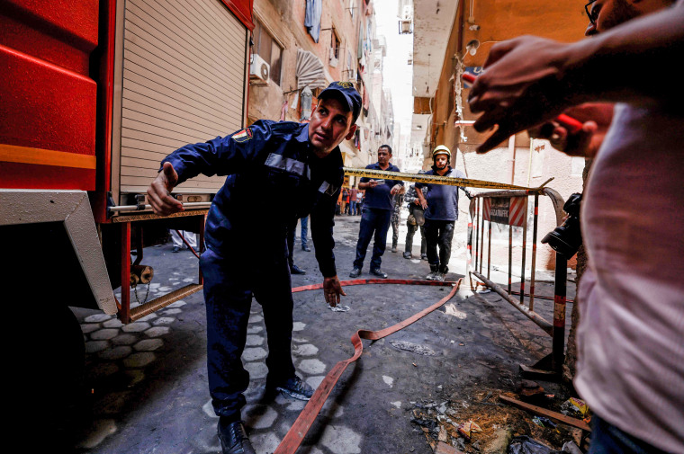 Egyptian firefighters respond to a fire at Abu Sifin, a Coptic Christian church, after more than 40 people were killed in the blaze in Cairo, Egypt, on Aug. 14, 2022.