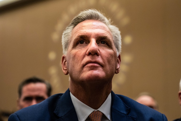 House Minority Leader Kevin McCarthy, R-Calif., listens as former President Donald Trump speaks at the American First Policy Institute's summit on July 26, 2022, in Washington.