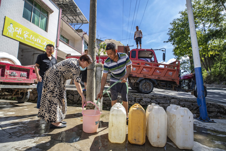 Water is distributed in Luoping village on Saturday. Unusually high temperatures and a prolonged drought are affecting large swaths of China.
