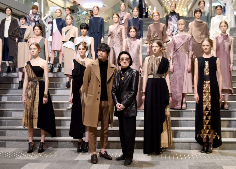 Japanese designers Yu Amatsu, center left, and Hanae Mori, center right, posing for photographers with their models after their 2017 Autumn/Winter Collection show at Tokyo Fashion Week in Tokyo.